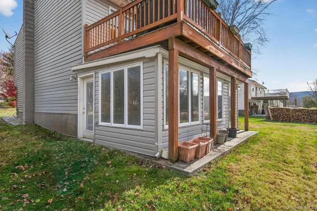 a view of a house with a large window and a yard