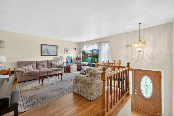 a living room with furniture a couch and a chandelier