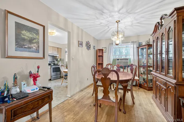 a view of a dining room with furniture and chandelier