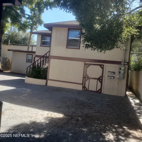 a backyard of a house with table and chairs