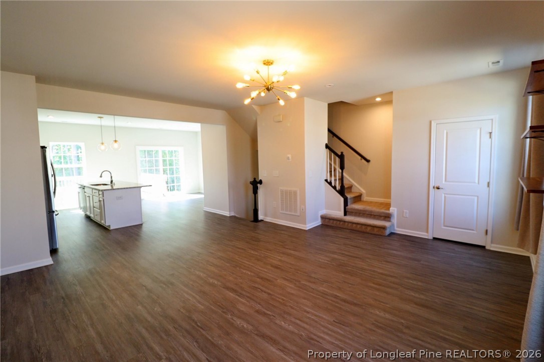 244 Amber Acorn Avenue Raleigh, NC 27603 - Photo 13 of 50 a view of a room with wooden floor and staircase