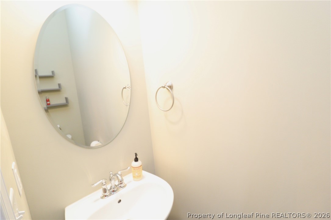 244 Amber Acorn Avenue Raleigh, NC 27603 - Photo 19 of 50 a bathroom with a sink and a mirror