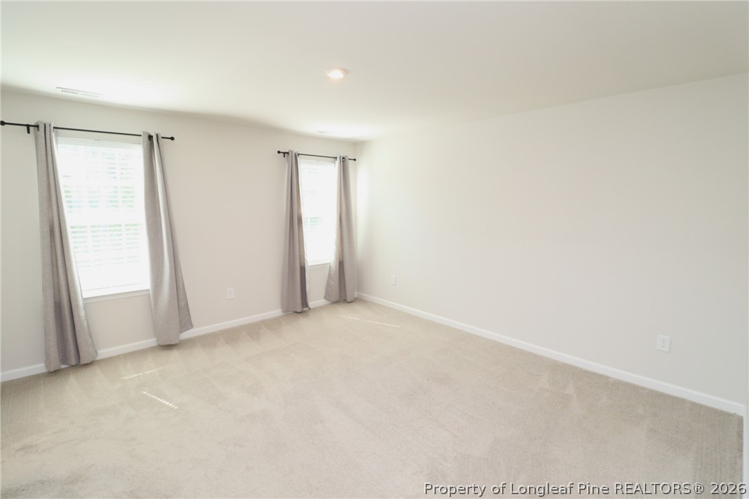 244 Amber Acorn Avenue Raleigh, NC 27603 - Photo 21 of 50 an empty room with windows