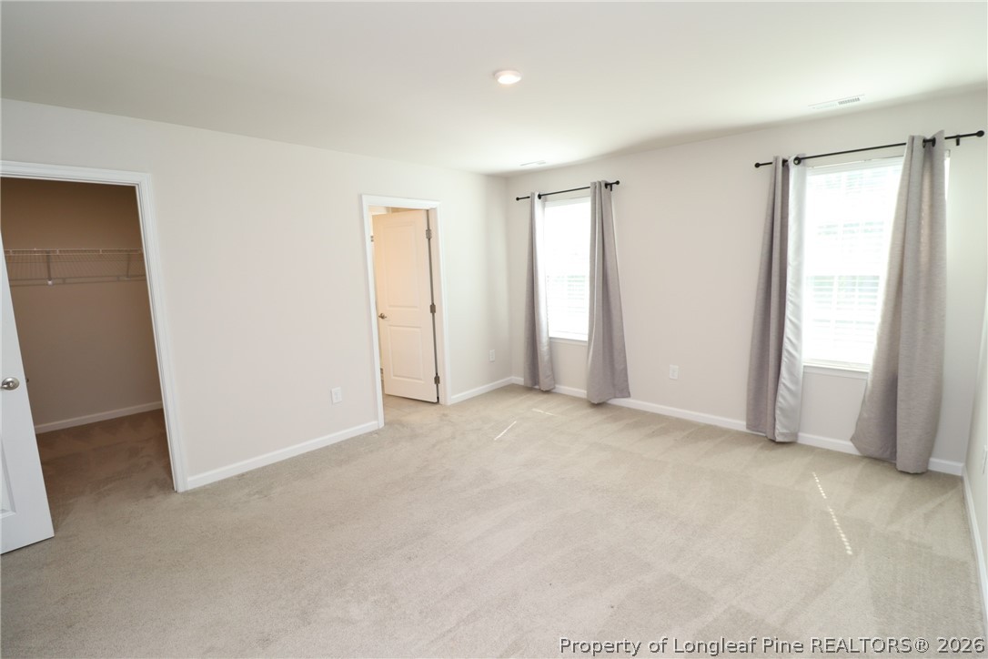 244 Amber Acorn Avenue Raleigh, NC 27603 - Photo 22 of 50 an empty room with windows