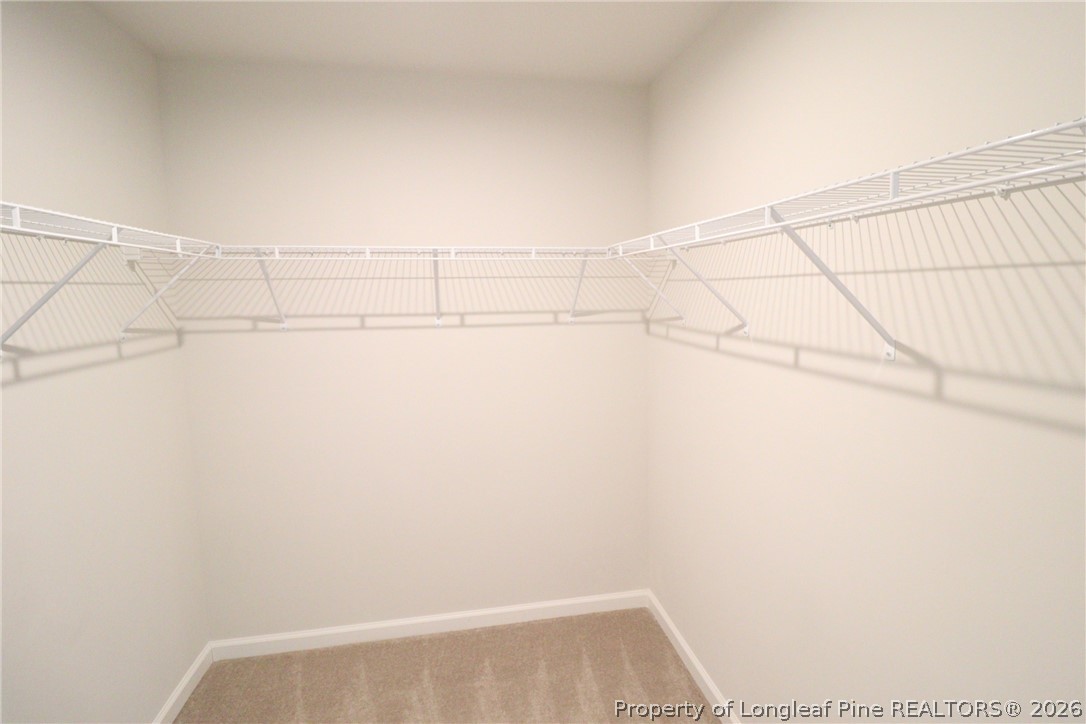 244 Amber Acorn Avenue Raleigh, NC 27603 - Photo 24 of 50 a view of a room with racks on the wall