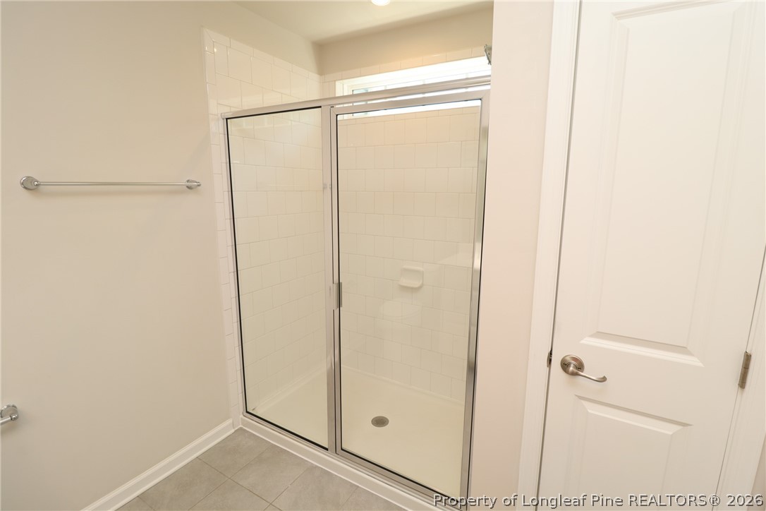 244 Amber Acorn Avenue Raleigh, NC 27603 - Photo 26 of 50 a bathroom with a glass shower door