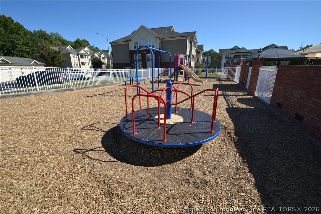 244 Amber Acorn Avenue Raleigh, NC 27603 - Photo 46 of 50 a view of a swimming pool with a table and chairs