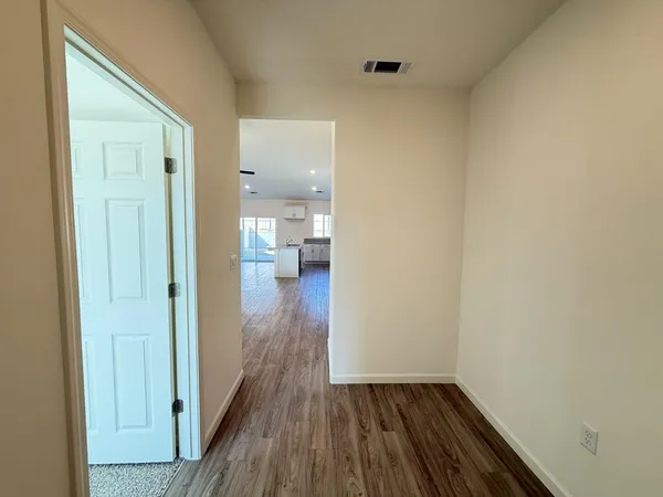 a view of a room with wooden floor