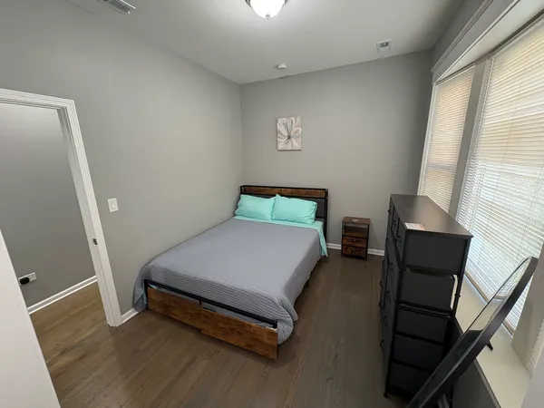 a bedroom with a bed and a window