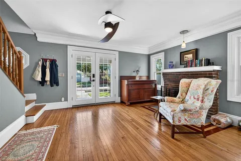 a living room with furniture and a wooden floor