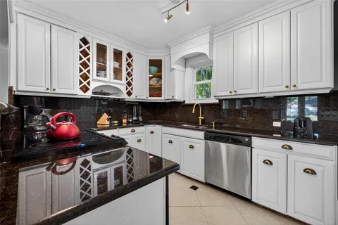 a kitchen with stainless steel appliances granite countertop a stove and cabinets