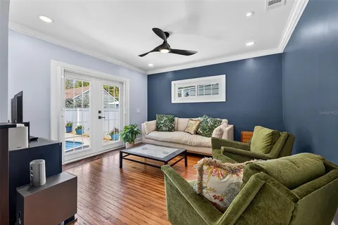 a living room with furniture and wooden floor