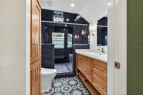 a bathroom with a sink a toilet and shower