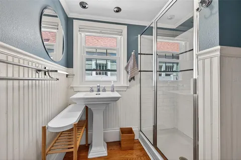 a bathroom with a sink a mirror and a shower
