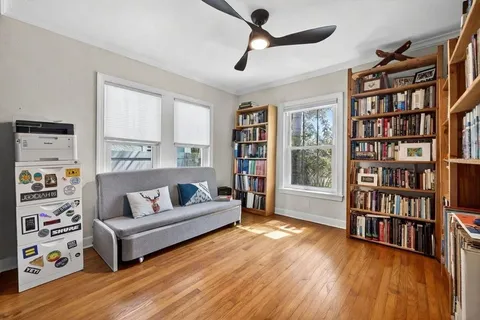 a living room with furniture and a book shelf