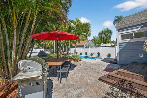 an outdoor space with patio table and chairs