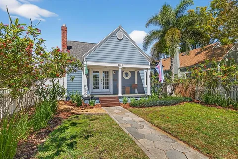 a front view of a house with a yard and fountain