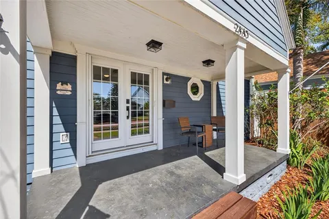 a view of a big room with wooden floor and windows