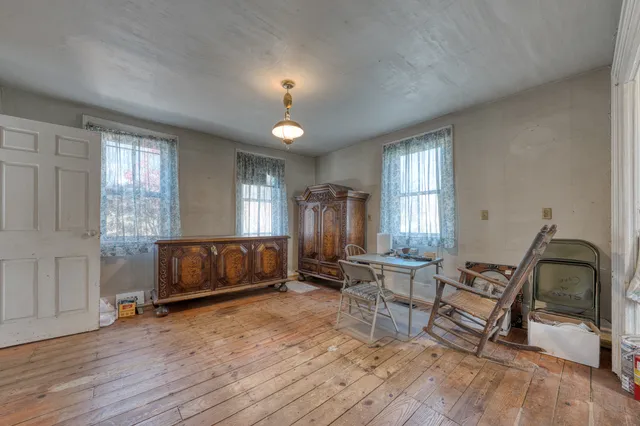 a kitchen with stainless steel appliances granite countertop a sink cabinets and a wooden floor