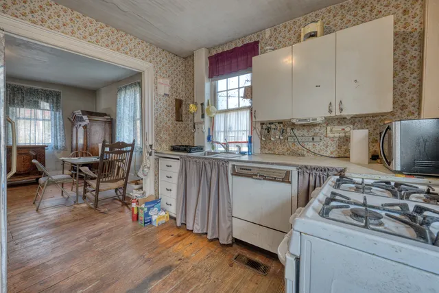 a living room with lots of furniture and a floor to ceiling window