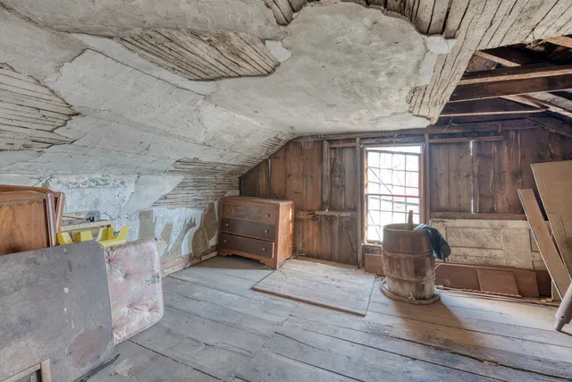 a view of living room filled with furniture and large window