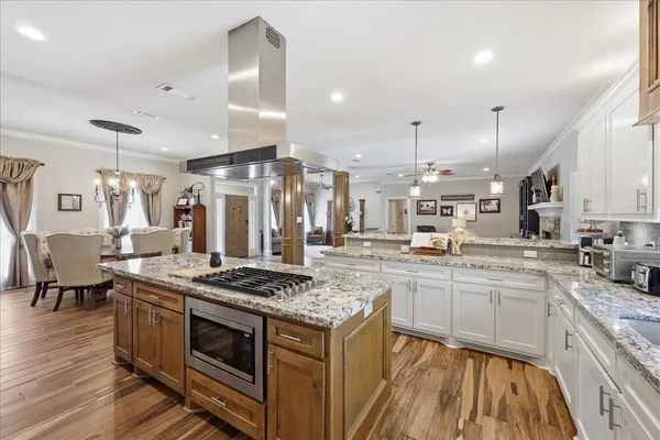 a kitchen with stainless steel appliances granite countertop a stove and a sink