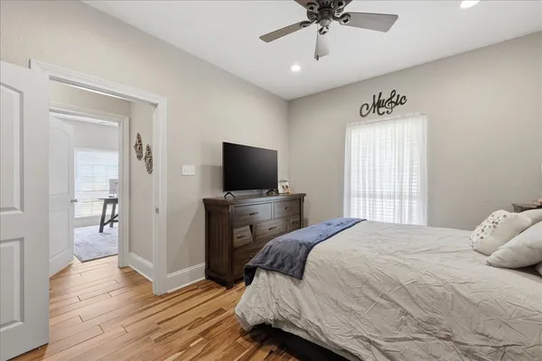 a bedroom with a bed and a flat screen tv