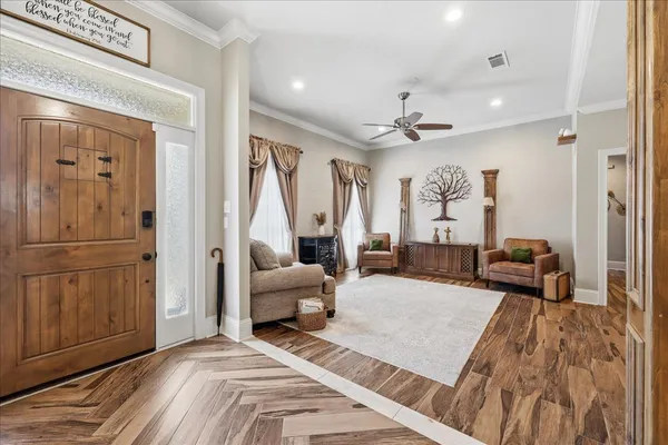 a bedroom with furniture and a wooden floor