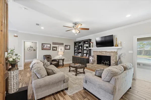 a living room with furniture a fireplace and a flat screen tv