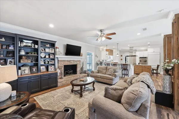 a living room with furniture a fireplace and a flat screen tv