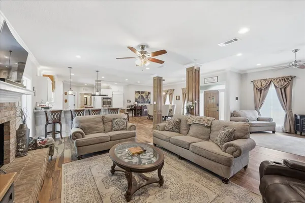 a living room with fireplace furniture and a chandelier