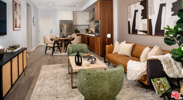 a kitchen with stainless steel appliances a dining table chairs stove and refrigerator