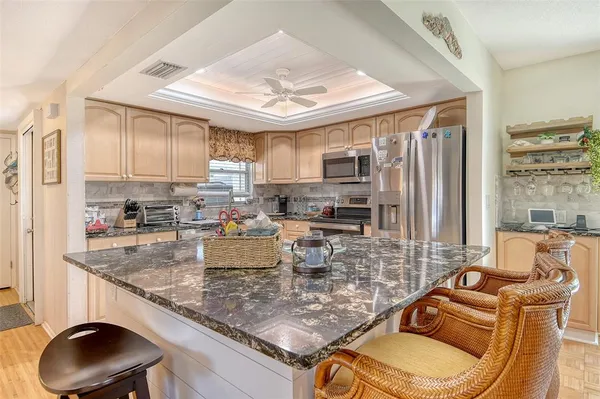 a bathroom with a granite countertop sink mirror and toilet