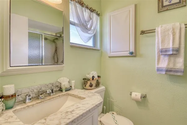 a front view of a building with palm trees