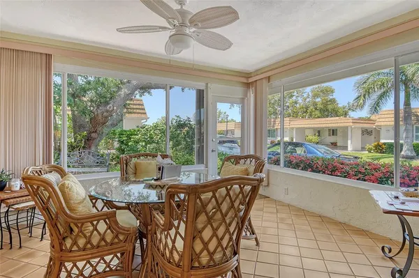 a living room with furniture kitchen view and a chandelier