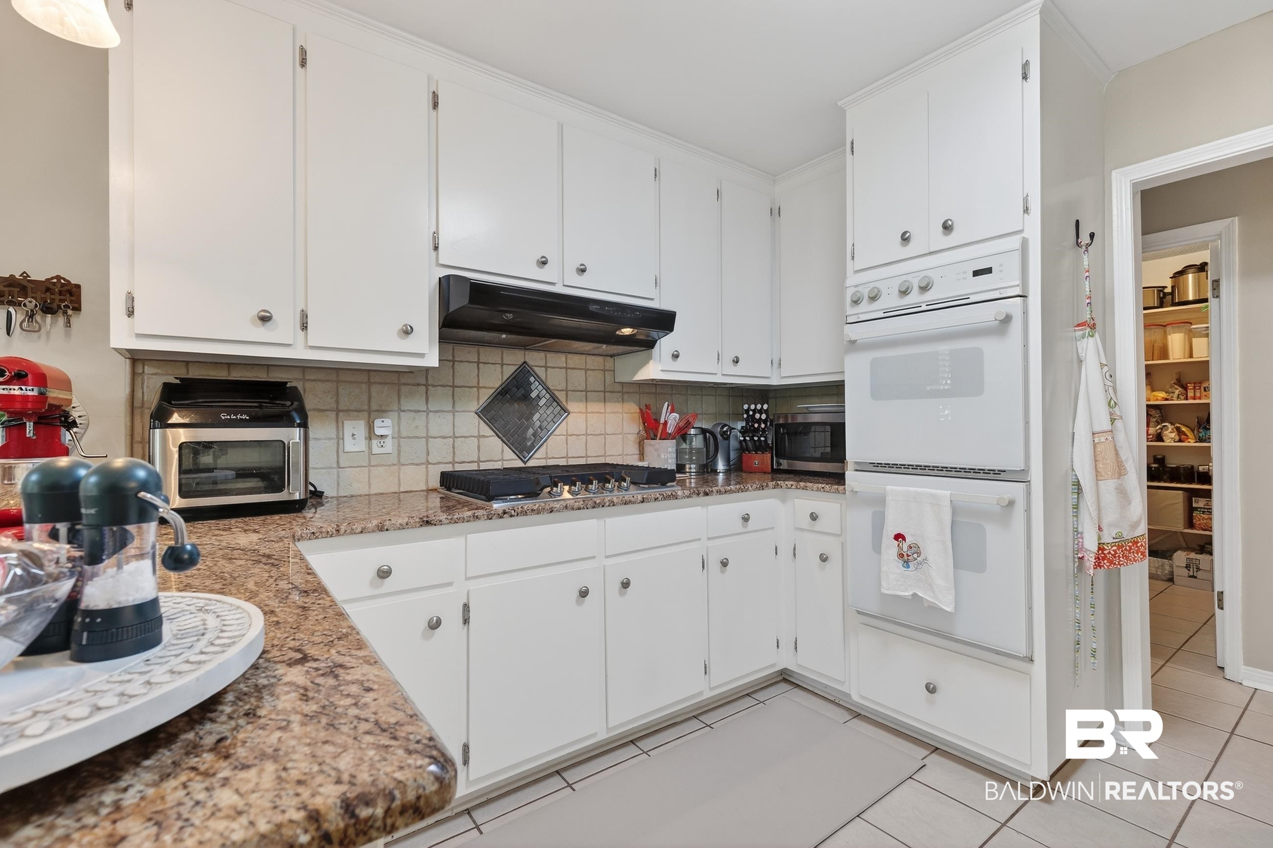 1271 Spring Valley Drive South Mobile, AL 36693 - Photo 18 of 56 Kitchen featuring stainless steel appliances, backsplash, dark stone counters, and light tile patterned floors