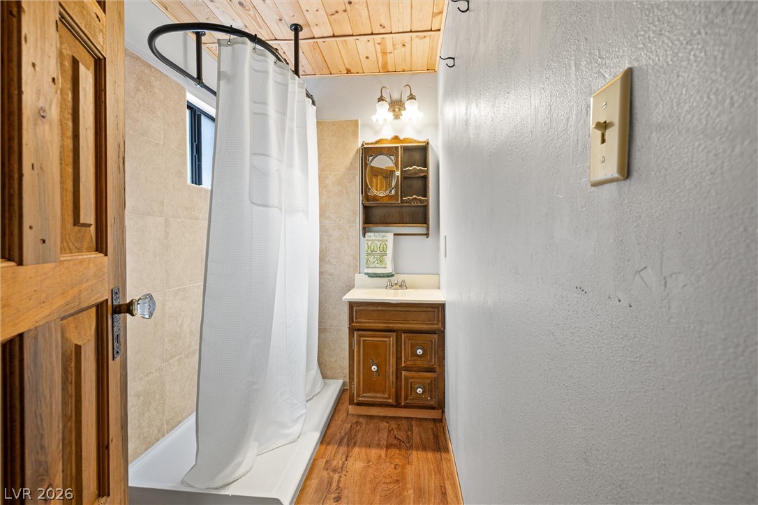 2146 Via Spes Nostra Street Mount Charleston, NV 89124 - Photo 23 of 33 Natural wood ceiling and warm flooring define this inviting bathroom, complete with a functional vanity.