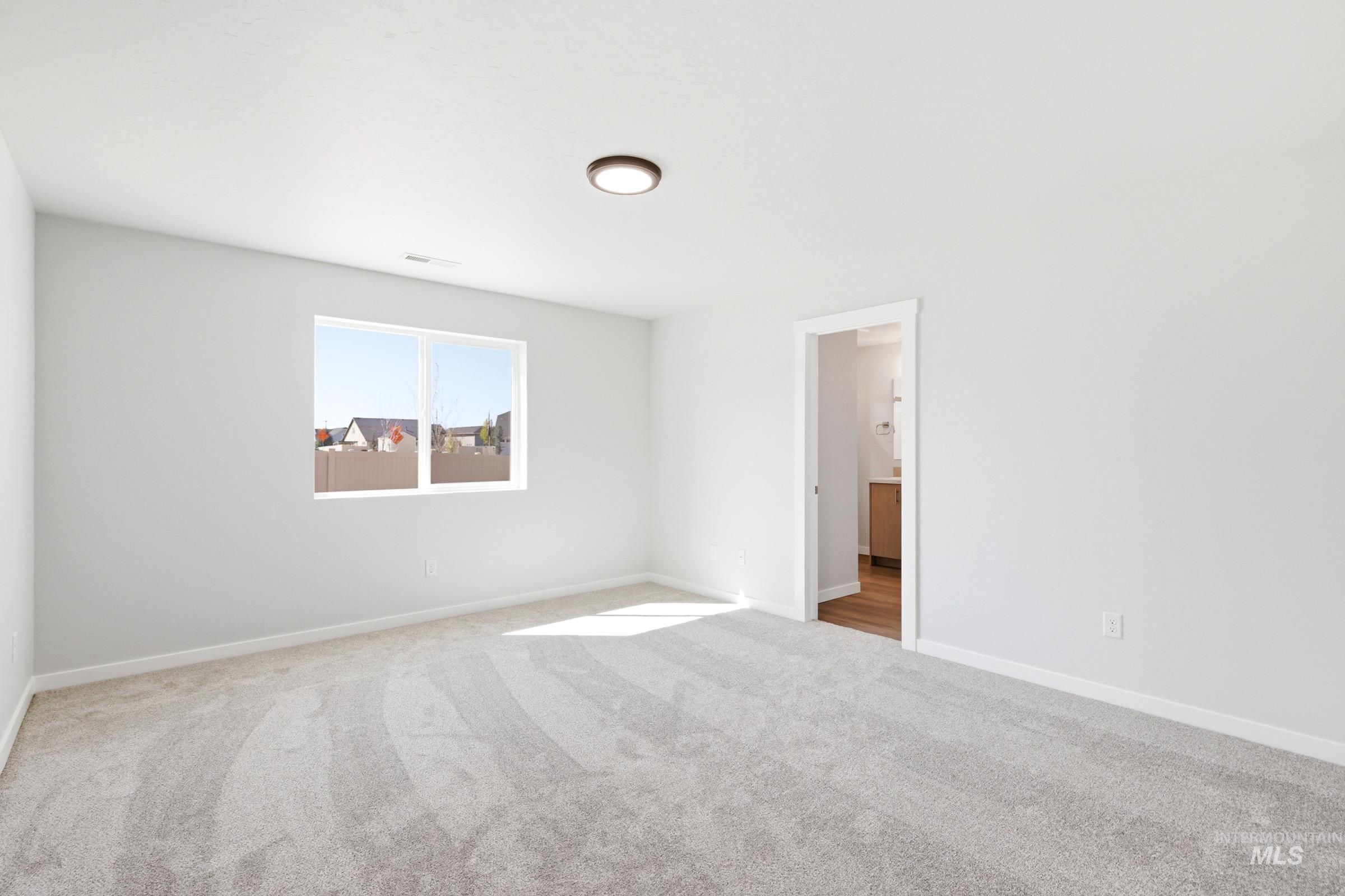 12877 Decatur Street Nampa, ID 83651 - Photo 20 of 22 Spacious room featuring light gray carpeting, neutral wall finishes, and a single window offering natural light