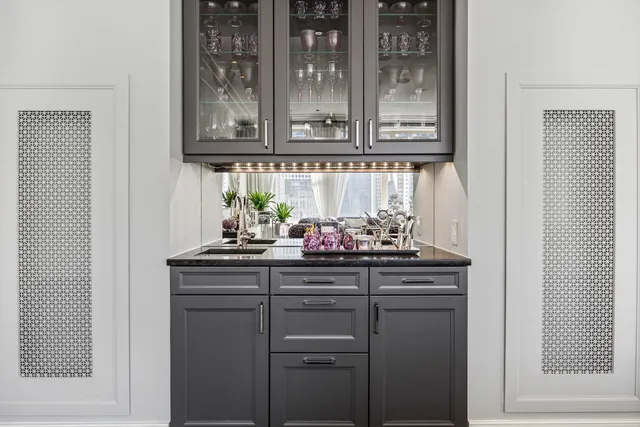 a kitchen with cabinets and wooden floor