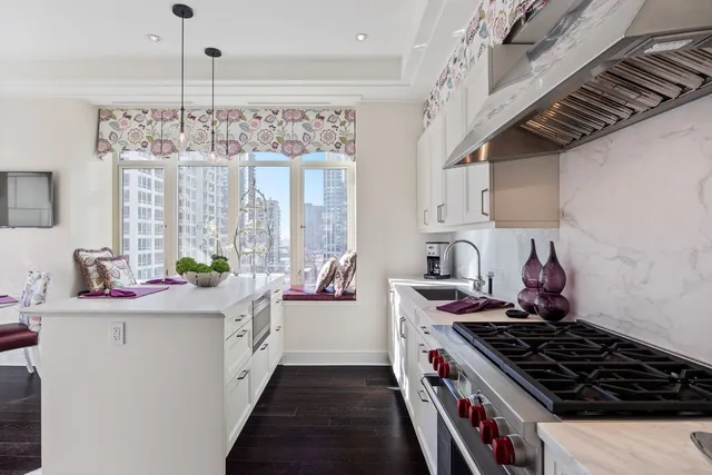 a kitchen with stainless steel appliances a sink stove and cabinets