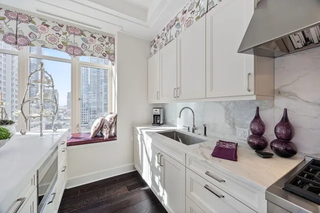 a kitchen with stainless steel appliances granite countertop a sink stove and cabinets