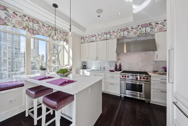 a kitchen that has a stove and a table