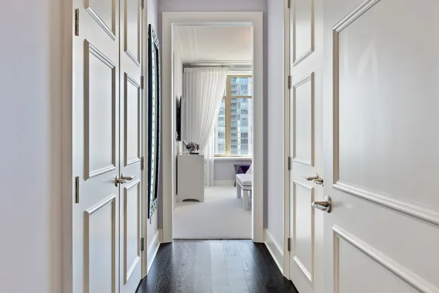 a spacious bedroom with a bed and a flat screen tv