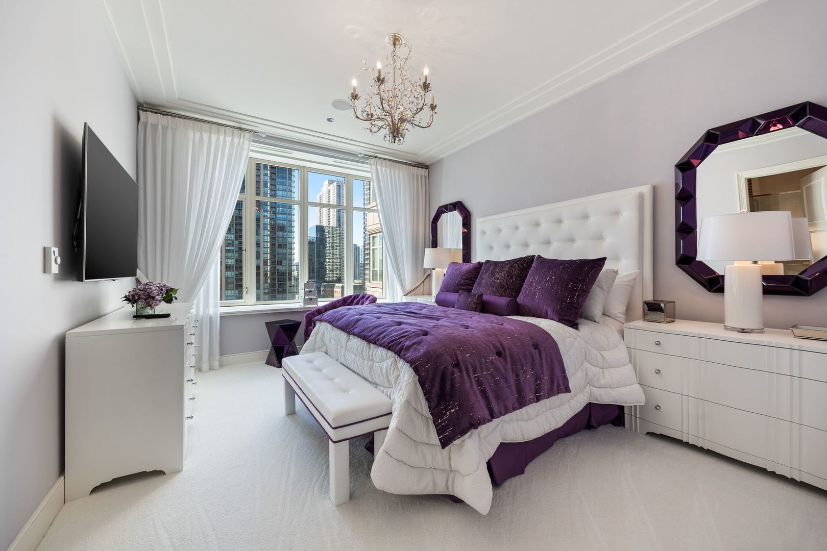 118 East Erie Street, Unit 18A Chicago, IL 60611 - Photo 23 of 40 a spacious bedroom with a bed and a flat screen tv