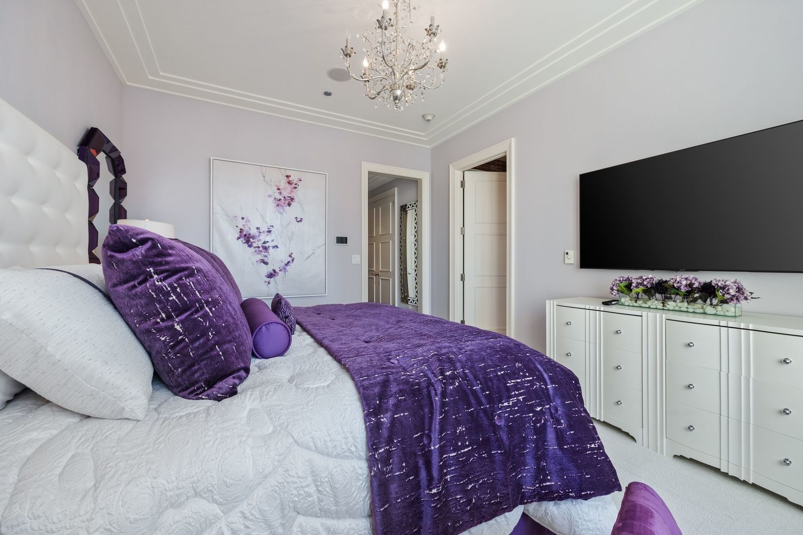 118 East Erie Street, Unit 18A Chicago, IL 60611 - Photo 24 of 40 a bedroom with a bed and a flat screen tv