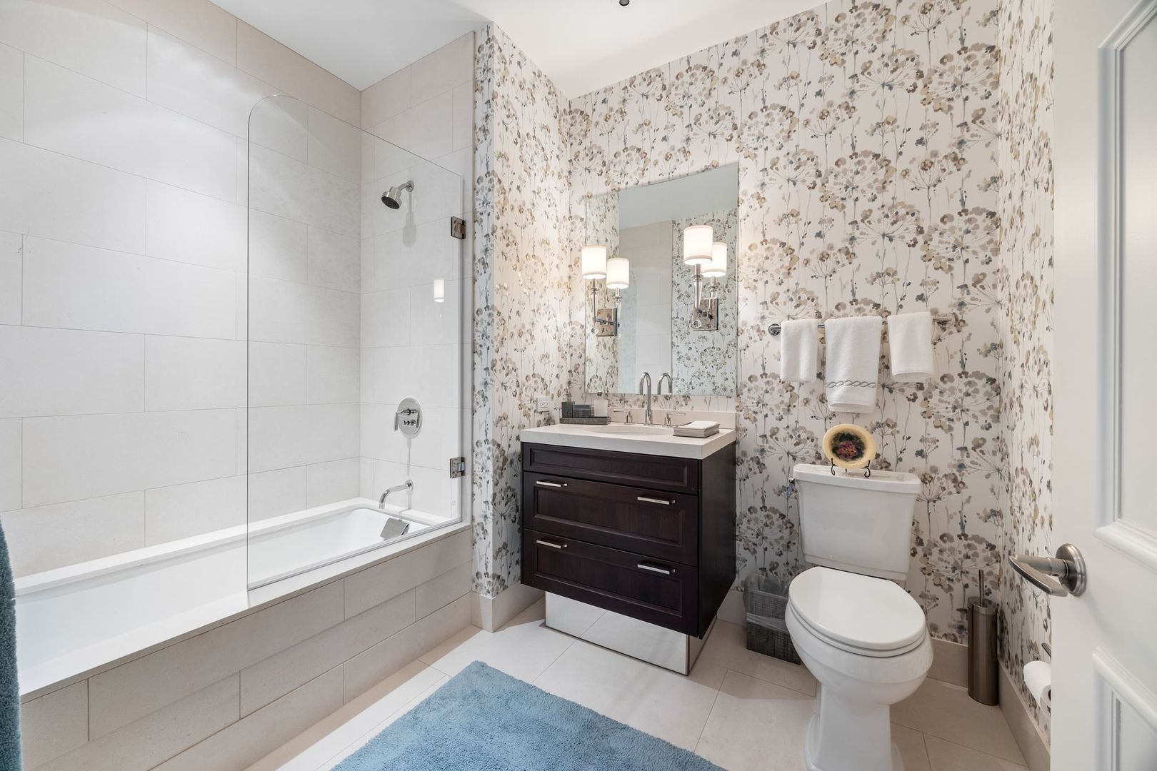 118 East Erie Street, Unit 18A Chicago, IL 60611 - Photo 31 of 40 a bathroom with a sink a toilet and shower