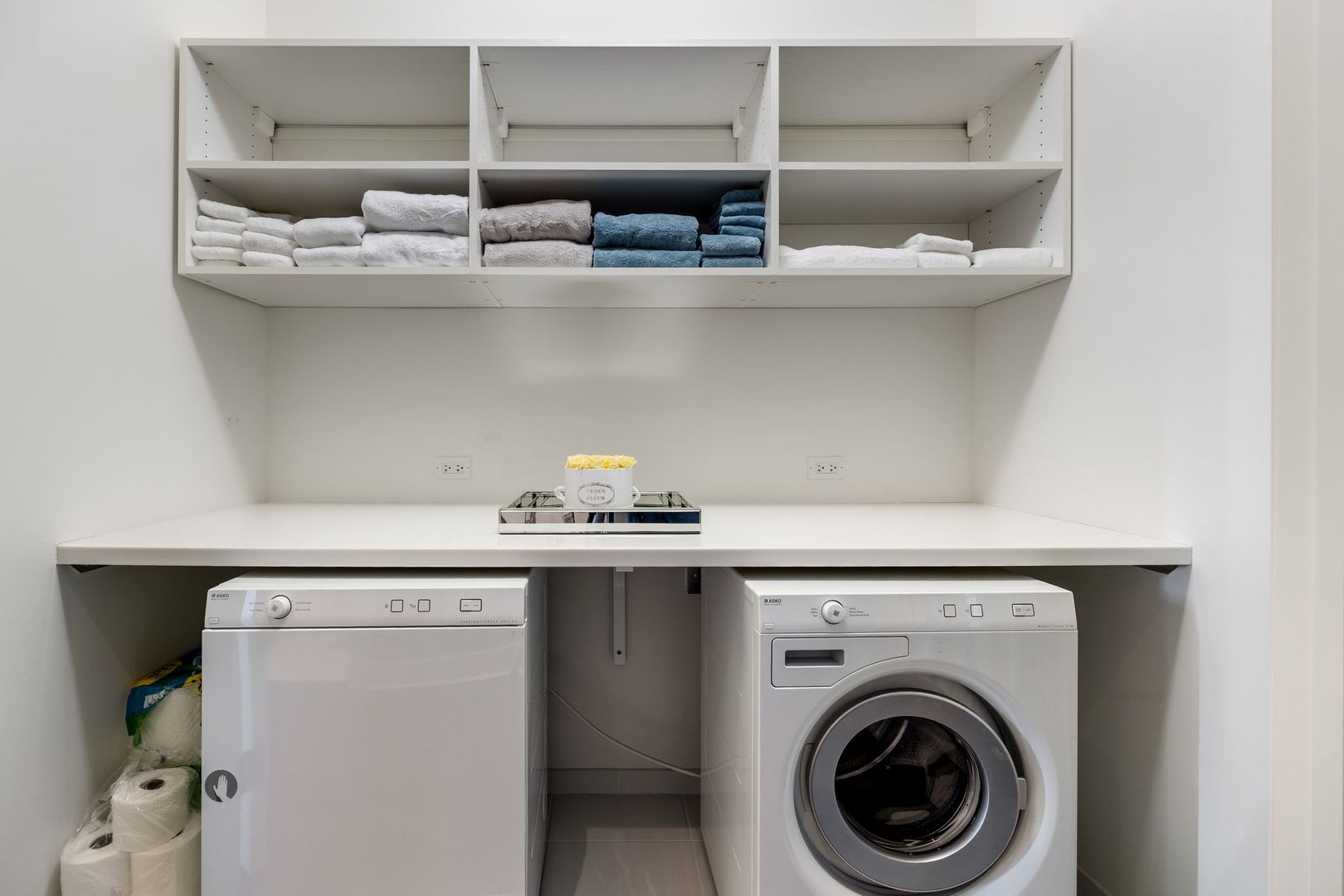 118 East Erie Street, Unit 18A Chicago, IL 60611 - Photo 33 of 40 a view of white cabinets with washer and dryer