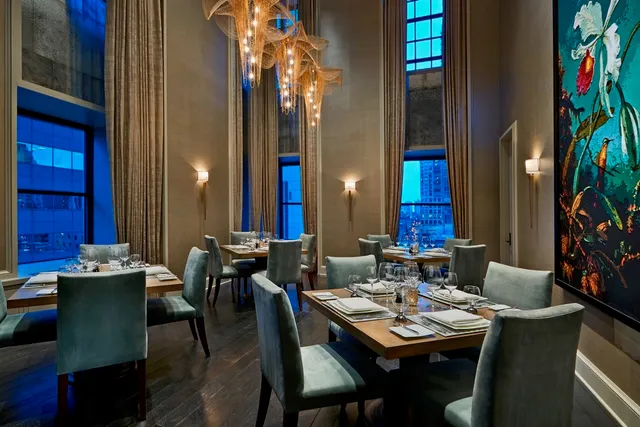 a living room with patio furniture and a chandelier