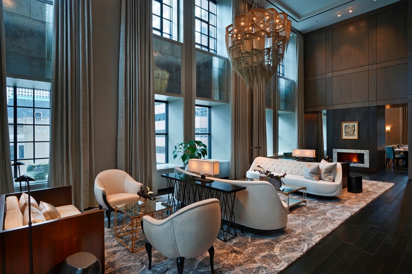 118 East Erie Street, Unit 18A Chicago, IL 60611 - Photo 35 of 40 a living room with patio furniture and a chandelier