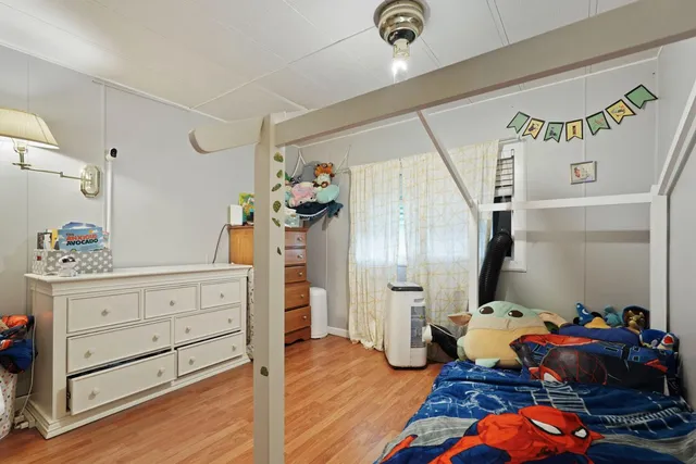 a bed room with a bed and a chandelier